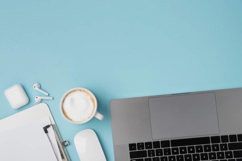 Top view desk with laptop clipboard