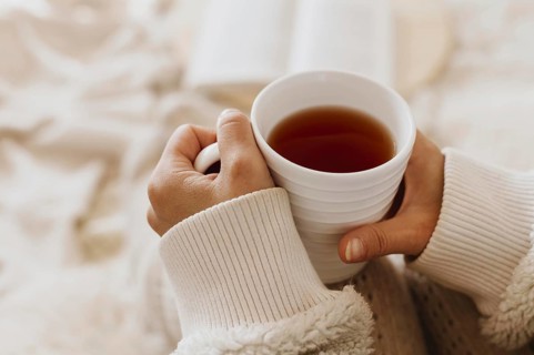 Young woman holding cup tea while enjoying winter holidays. Resolution and high quality beautiful