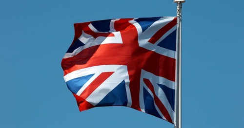 British Flag Waving in the Wind against blue sky