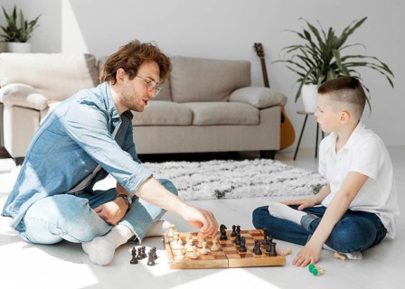 Tutor learning boy how play chess