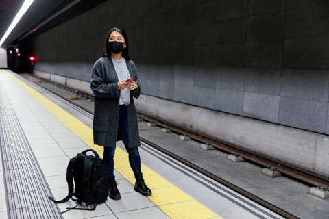 Young woman with mask subway station