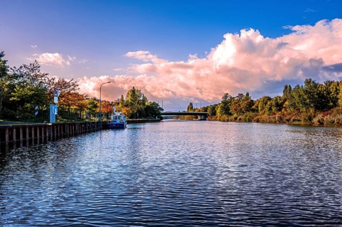 The Mittelland Canal in Hanover in the district of Vahrenwald in sunshine, white clouds and blue