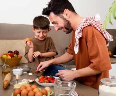 Medium shot father kid cooking together