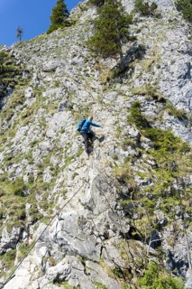 Climber, senior citizen, 66, climbing via ferrata on the Ettaler Mandl, Oberammergau, Ammergau