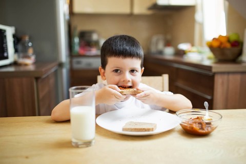 Baby boy having breakfast home