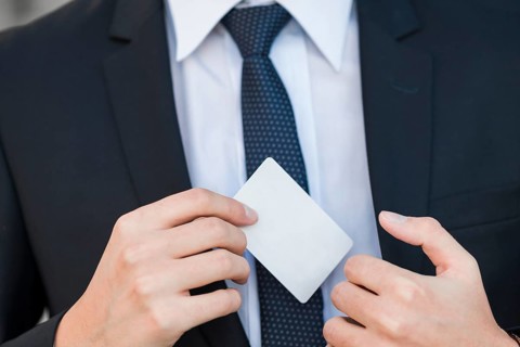 Elegant businessman showing business card