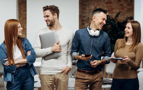 Smiley coworkers talking office