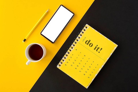 Top view planner yellow calendar coffee