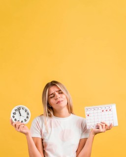 Woman holding clock menstrual calendar copy space