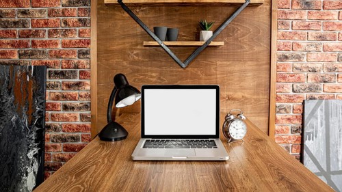 Front view laptop office workspace with lamp
