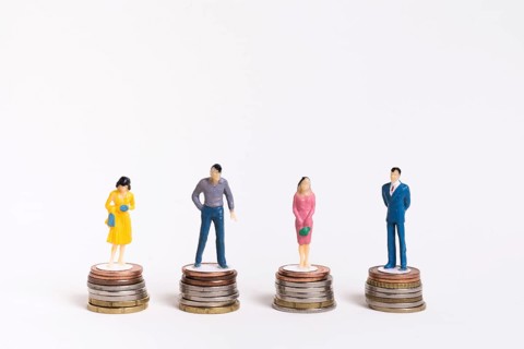 Business man woman sitting equal piles coins
