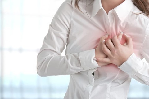 Woman having a pain in the heart area