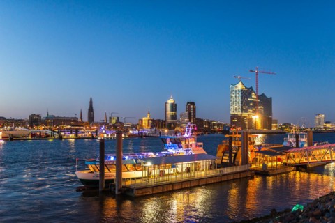 Night picture from the illuminated skyline of Hamburg at the Elbe river with the attractions Elbe