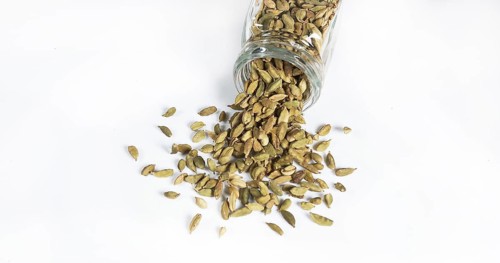 Cardamom (elettaria Cardamomum), spice falling against White Background
