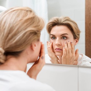 Woman checking her eyes mirror