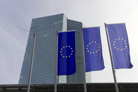 The new European Central Bank, ECB, European flags fly in front of a modern high-rise building with