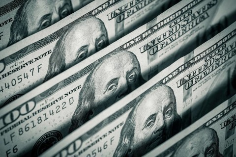 Hundred dollars bills standing in a row. Selective focus