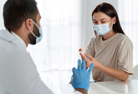 Woman with medical mask talking doctor