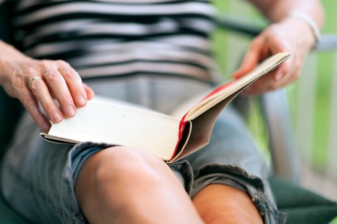 Close-up of a woman reading a book