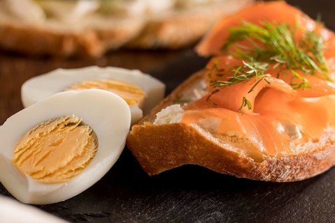Close up sandwich slate with salmon hard boiled egg