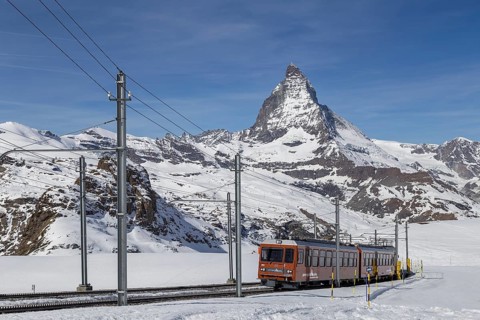 Zermatt, Switzerland, April 12, 2017: The red Gornergrat Train in front of the snowy Matterhorn