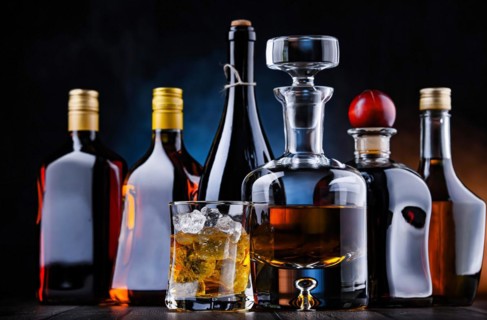 Composition with bottles of assorted alcoholic beverages