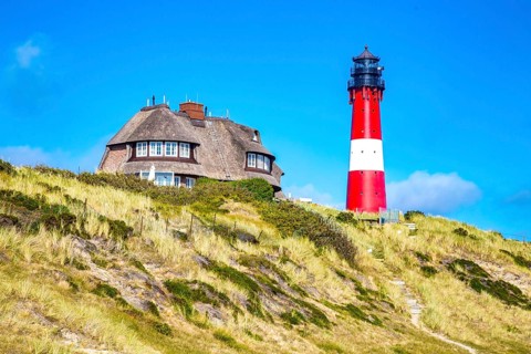 Lighthouse and thatched-roof villa of the Kersig estate in the dunes, Hörnum, Sylt