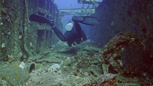 Scuba diver swim down corridor of ferry Salem Express shipwreck, Red sea, Safaga, Egypt, Africa