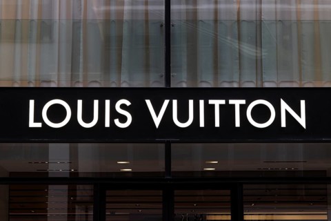 Close-up, logo of the French luxury fashion brand Louis Vuitton on a boutique in the shopping