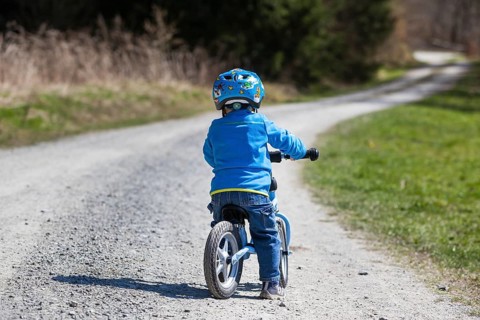 Child with a running bike