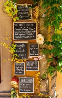 Riquewihr, France - 30 May, 2022: close-up view of many handwritten signs in French language