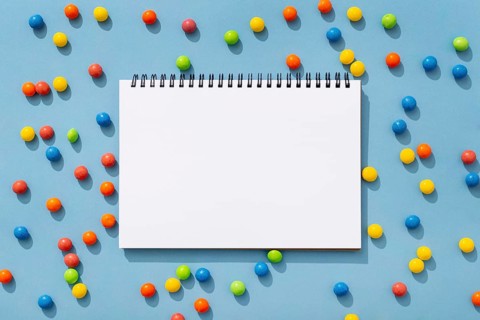 Top view colorful jelly beans with notebook