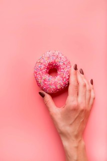 Top view hand holding donut