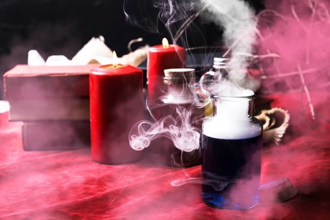 Smoky blue potion with halloween decorations