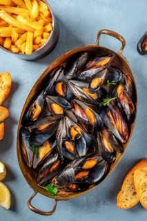 Moules frites, Belgian mussels with French fries, shot from above
