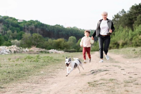 Family enjoying walk park with dog