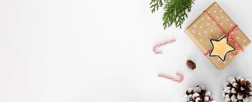 Top view christmas gift with pine cones candy canes
