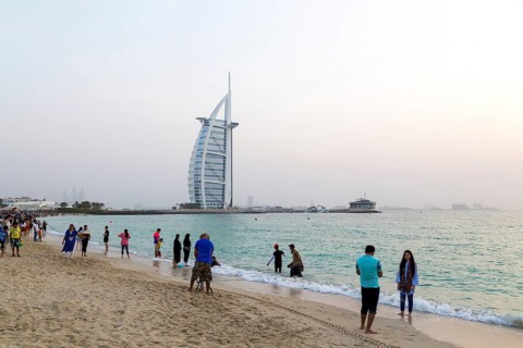 Dubai, UAE, July 20, 2018: Locals and tourists enjoy a Friday evening at Jumeirah Public Beach