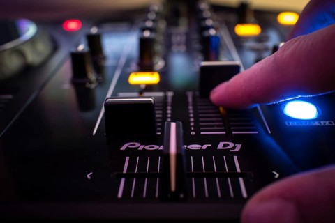 Dj console and hand, bokeh, Pioneer DJ