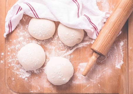 Yeast dough for making braided cakes, pies, pizza and rolls with rolling pin. Preparing leavened