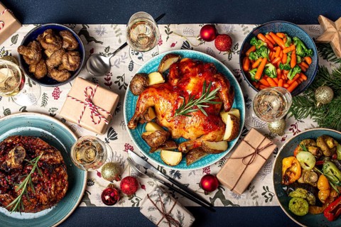 Christmas evening table top view with festive food and sparkling wine glasses, Xmas dinner with