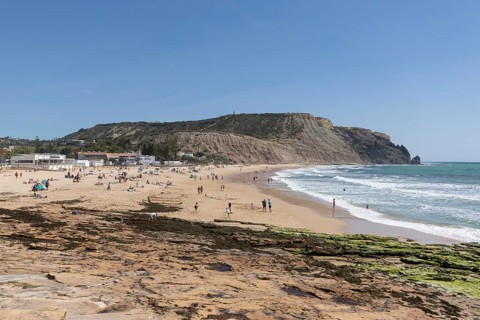 Bathers on the sandy beach in Praia da Luz, Faro district, Algarve, Portugal, Europe
