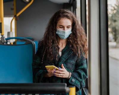 Woman with curly hair wearing medical mask front view