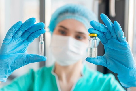 Nurse holding ampoule