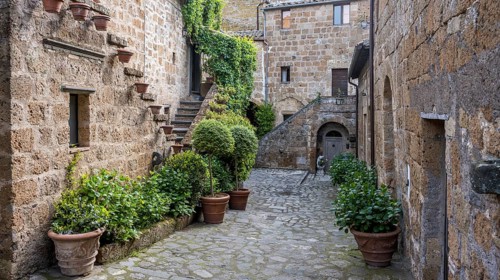 Old tufa buildings decorated with flowers in the hilltop village of Civita di Bagnoregio, Lazio,
