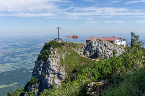 Air rescue helicopter flies to Hochfelln mountain, Bergen, Chiemgau, Upper Bavaria, Germany, Europe