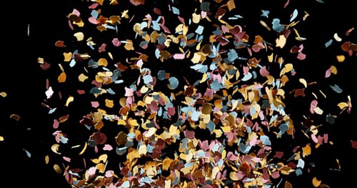 Confettis Falling against Black Background