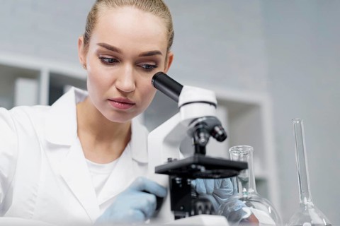 Female researcher laboratory with microscope