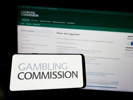 Stuttgart, Germany, 04-01-2023: Person holding smartphone with logo of British public body Gambling