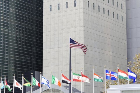 UN Headquarters, East River, Manhattan, row of international flags against the background of a
